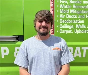 SERVPRO employee in front of green background