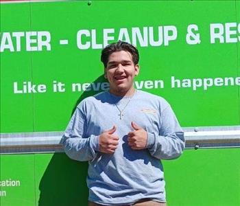 SERVPRO employee in front of green background