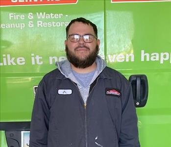 SERVPRO employee in front of green background